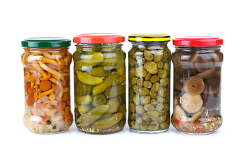 Image showing Glass jars with marinated cornichons, mushrooms and capers