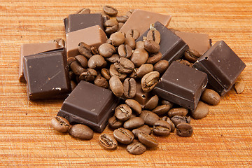 Image showing Chocolate and coffe beans on wooden plate