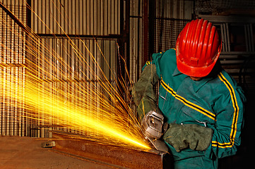 Image showing heavy industry manual worker with grinder 