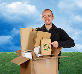 Image showing grass and sky man recycling paper