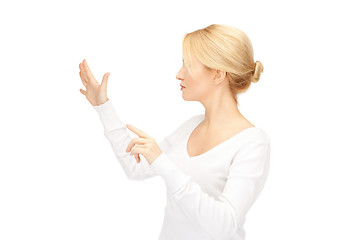 Image showing businesswoman working with something imaginary