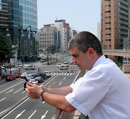 Image showing Man with mobile phone in a city