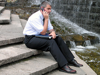 Image showing Man with phone and computer