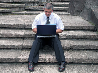 Image showing Businessman with laptop outdoor