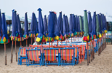 Image showing Empty beach chairs and parasols