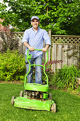 Image showing Man mowing lawn