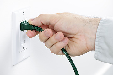 Image showing Hand removing plug from outlet