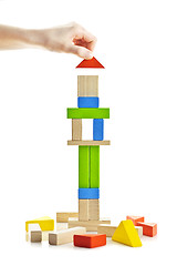 Image showing Wooden block tower under construction