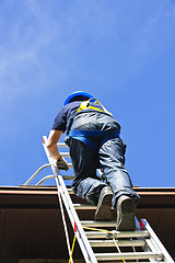 Image showing Construction worker climbing ladder