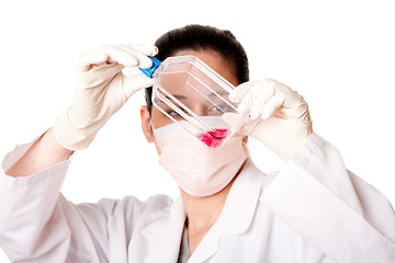 Image showing Female scientist looking at tissue culture flask