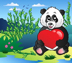 Image showing Cartoon panda holding heart outdoor