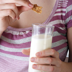 Image showing Young people eating milk with cereals