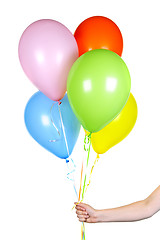 Image showing Hand holding balloons on white