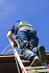 Image showing Construction worker climbing ladder