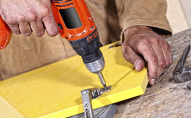 Image showing carpenter with red drill