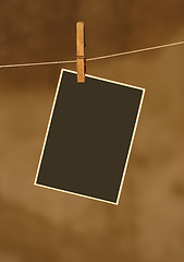 Image showing  photo on metal rope with wood Clothespins 
