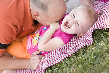 Image showing Loving Dad Tickles Daughter in Park