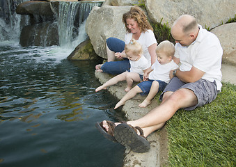 Image showing Young Family with Twins Enjoy Water in Park