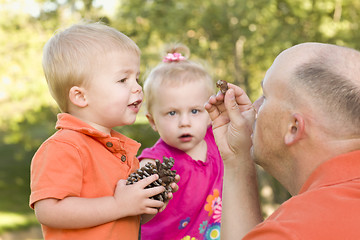 Image showing Cute Twin Children Talk with Dad in Park