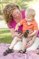 Image showing Mother and Son Talk about Pine Cones in Park