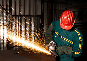 Image showing heavy industry manual worker with grinder