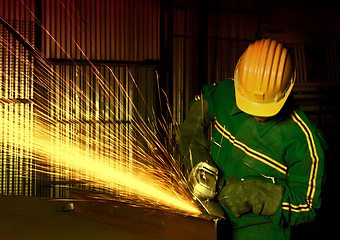 Image showing heavy industry manual worker with grinder