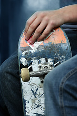 Image showing Kid holding a skateboarder