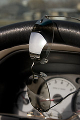 Image showing Sunglasses on the steering wheel