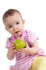Image showing Baby girl in pink eating apple