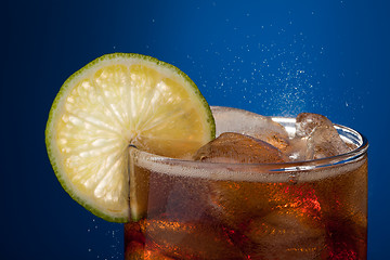 Image showing Close-up glass of cola with lime