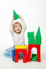 Image showing Blond little girl building house