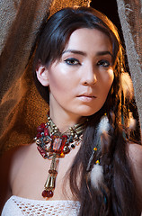 Image showing Portrait of American Indian female looking from tent