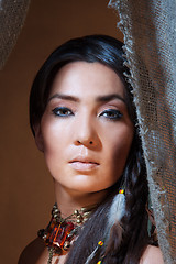 Image showing American Indian woman looking from the tent