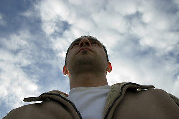 Image showing Man Looking up with the Clouds on the Background