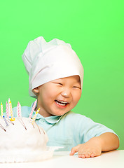 Image showing Happy boy with just cooked cake