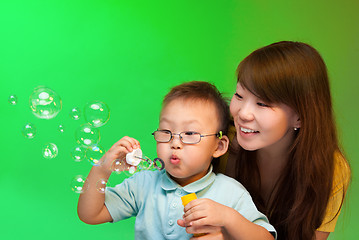 Image showing Mother and son make soap bubbles