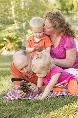 Image showing Young Family Talking about Pine Cones in Park