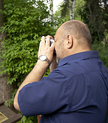 Image showing Photographer filming in the park