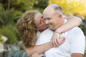 Image showing Attractive Couple Kiss on the Cheek in the Park.