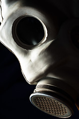 Image showing Closeup of a dark gasmask with blurs