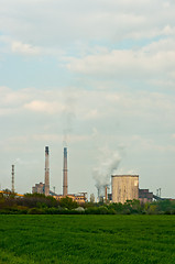 Image showing power plant with green grass and smoke rising