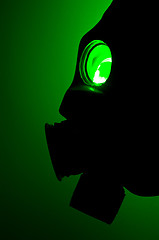 Image showing Silhouette of a gas mask in green light