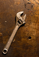 Image showing Adjustable wrench on rusty metal plate