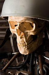 Image showing close up of a robot with human skull and helmet