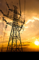 Image showing Angle shot of power lines against sunset in the background