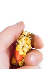 Image showing Hand holding medicine bottle full of pills