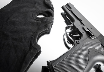 Image showing Pistol and mask of a thief over white