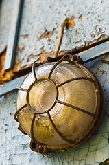 Image showing Old and dirty lamp on blue abandoned wall