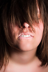 Image showing Girl biting her lips with sugar on it