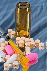 Image showing Medicine bottle and sirynge and pills and reflection